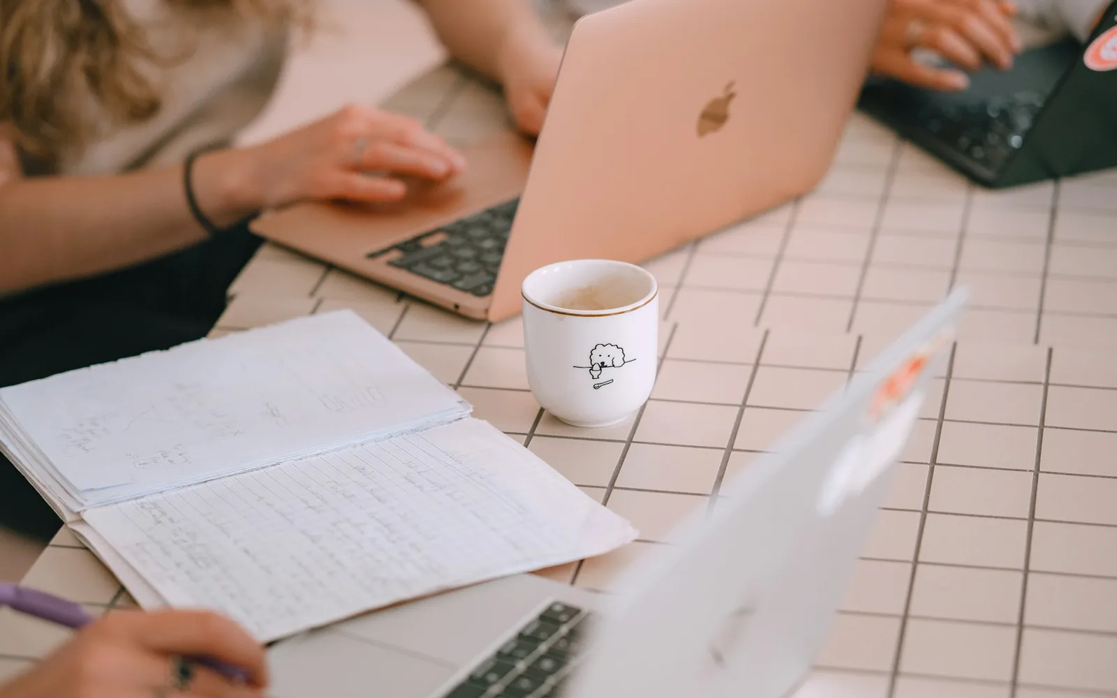 Planning content with a laptop and handwritten notes.