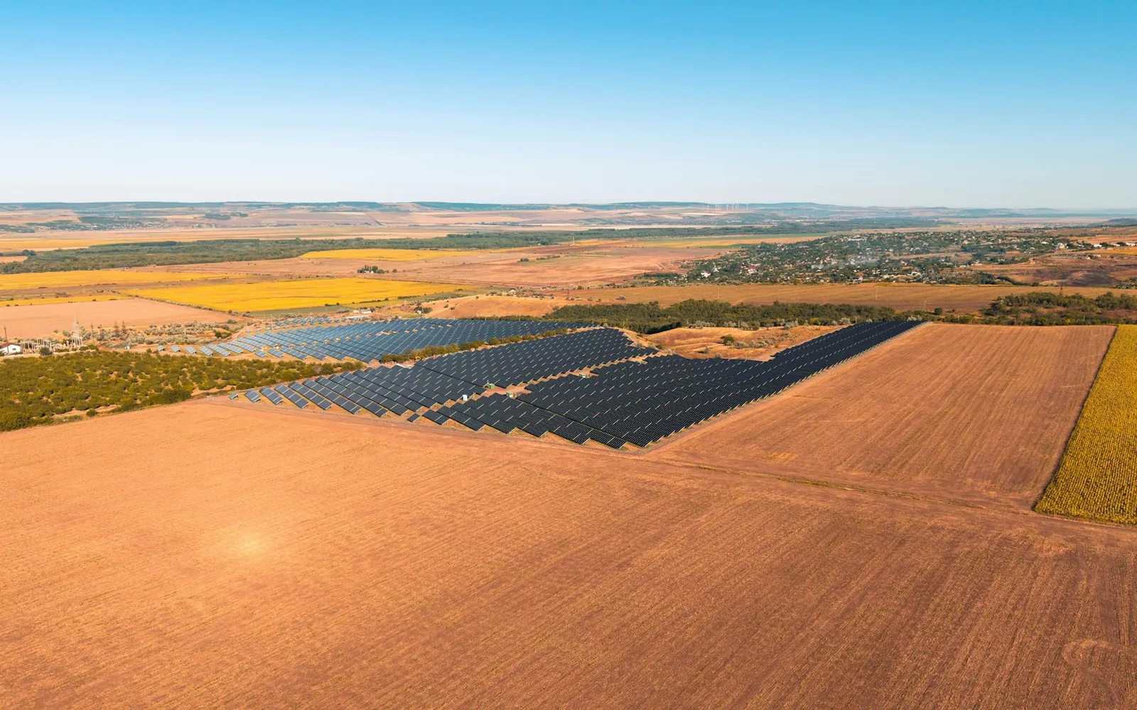 Solar panels set within an agricultural landscape.
