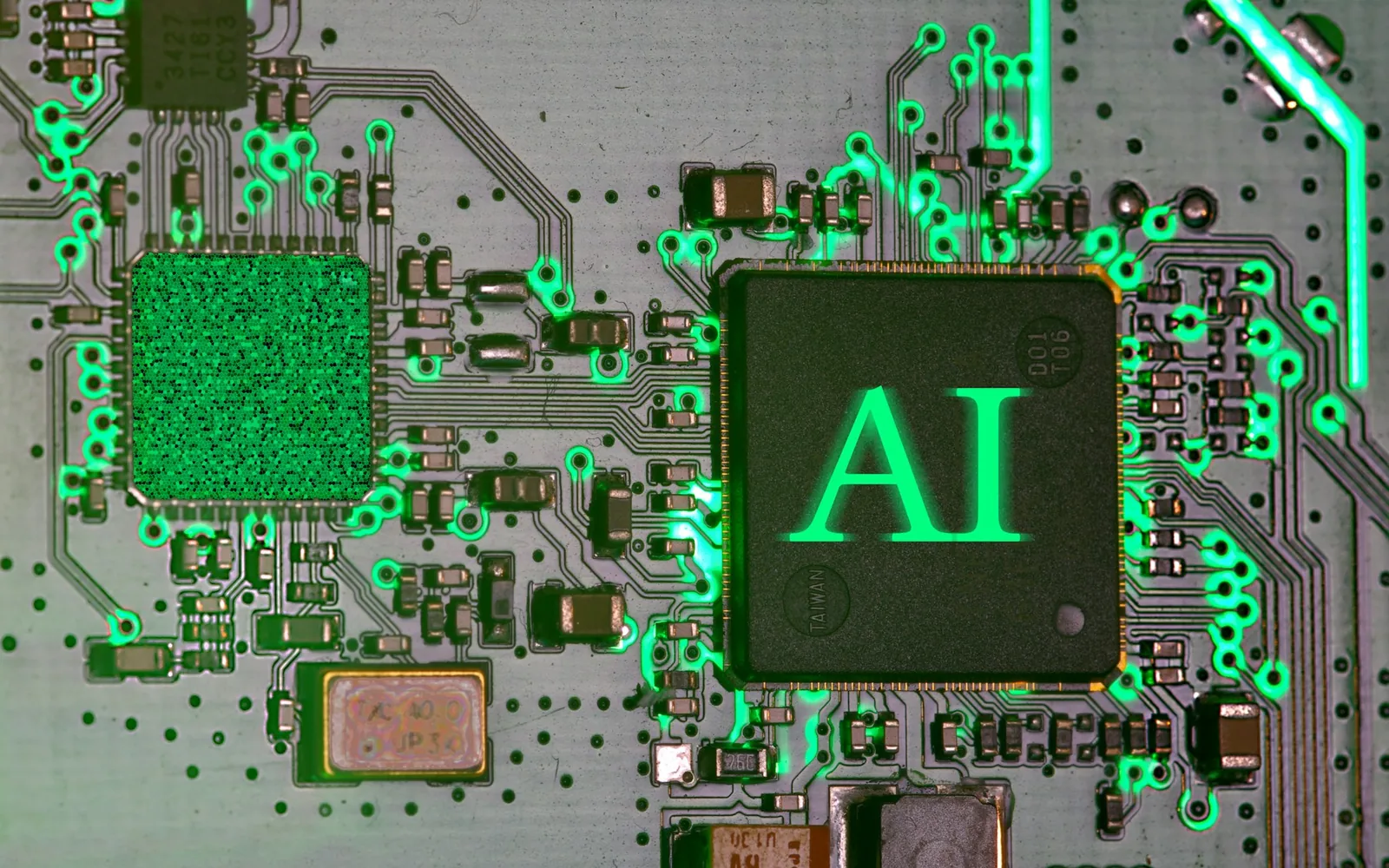 A close-up of a circuit board with an illuminated AI chip.